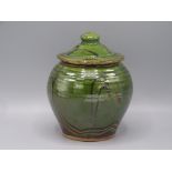 A Clive Bowen Studio Pottery jar and cover, with a ribbed green glazed body, height 19.5cm.