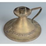 An Arts and Crafts Arthur John Seward brass chamber candlestick,