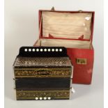 A Hohner penwork accordion, width 28cm, in a red leather box.