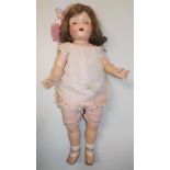 A composition shoulder plate head doll, the head with sleep eyes,