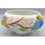 A Clarice Cliff pottery bowl, with two parrots perched on a branch, height 12cm, diameter 20cm.