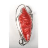 A silver Newlyn Enamel brooch of asymmetric design, with a basse-taille enamelled red panel,
