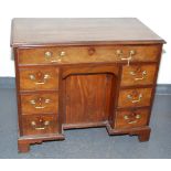 A George III mahogany kneehole desk,