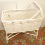 A 1950s wicker work white painted cot, together with a small green painted wood cot.