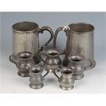 Two pewter tankards and five measures, height of largest 12.5cm.