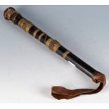 An African brass wire bound club with a leather wrist strap length 32cm.