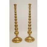 A large pair of brass altar candlesticks, early 20th century, height 55cm.