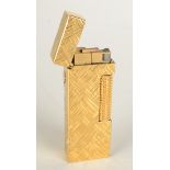 A gold plated ice textured Dunhill gas Swiss Made Rollagas lighter boxed with booklet.