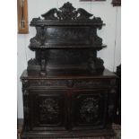 A Victorian carved oak sideboard, the upper part with carved fruit decoration and two tiers,