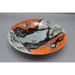 A shallow lustre glaze pottery bowl by Juliet Shotton, the interior painted with stylised figures,