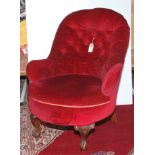A late Victorian tub armchair, the button upholstered back, padded arms and seat,