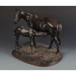 A Soviet 1972 cast iron model of mare and foal on an naturalistic base, marked to the base Kacni,