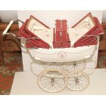 A twin pram in red and white by Silver Cross together with matching shopping bag which can be