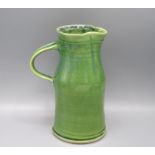 An Arwin Jones Studio Pottery jug, with a green glazed ribbed body, height 19cm.