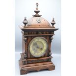 A Victorian oak mantel clock, surmounted by three turned finials, height 51cm.