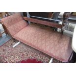 An Edwardian walnut chaise longue, upholstered in patterned pale pink fabric,