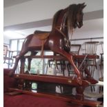 A good well carved polished wood rocking horse, with horse hair main and tail,