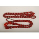 Two cherry amber long bead necklaces,