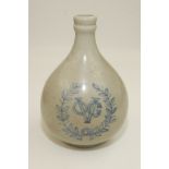 A Dutch East Indies blue and white bottle vase with the company arms within a wreath, height 22cm.