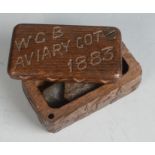 A small carved wood box inscribed 'W.G.B AVIARY CO.