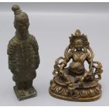 A South East Asian bronze figure of a seated deity, floral symbol to base, height 7.5cm.