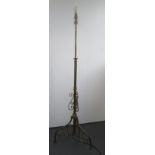 A brass and wrought iron standard lamp, early 20th century,