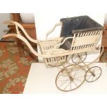 A nineteenth century wood and wicker baby carriage, original leather cloth interior,