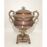 A copper tea urn, 19th century, the pineapple finial above acanthus leaf decorated handles,