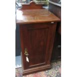 An Edwardian mahogany bedside cabinet, with a single rectangular panelled door and plinth base,