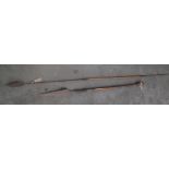 Two tribal carved wood and metal spears, one with a fluted handle, lengths 250cm and 147cm.