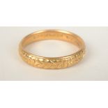 A chased 22ct gold band by Bravingtons Ltd London, 6.1g.