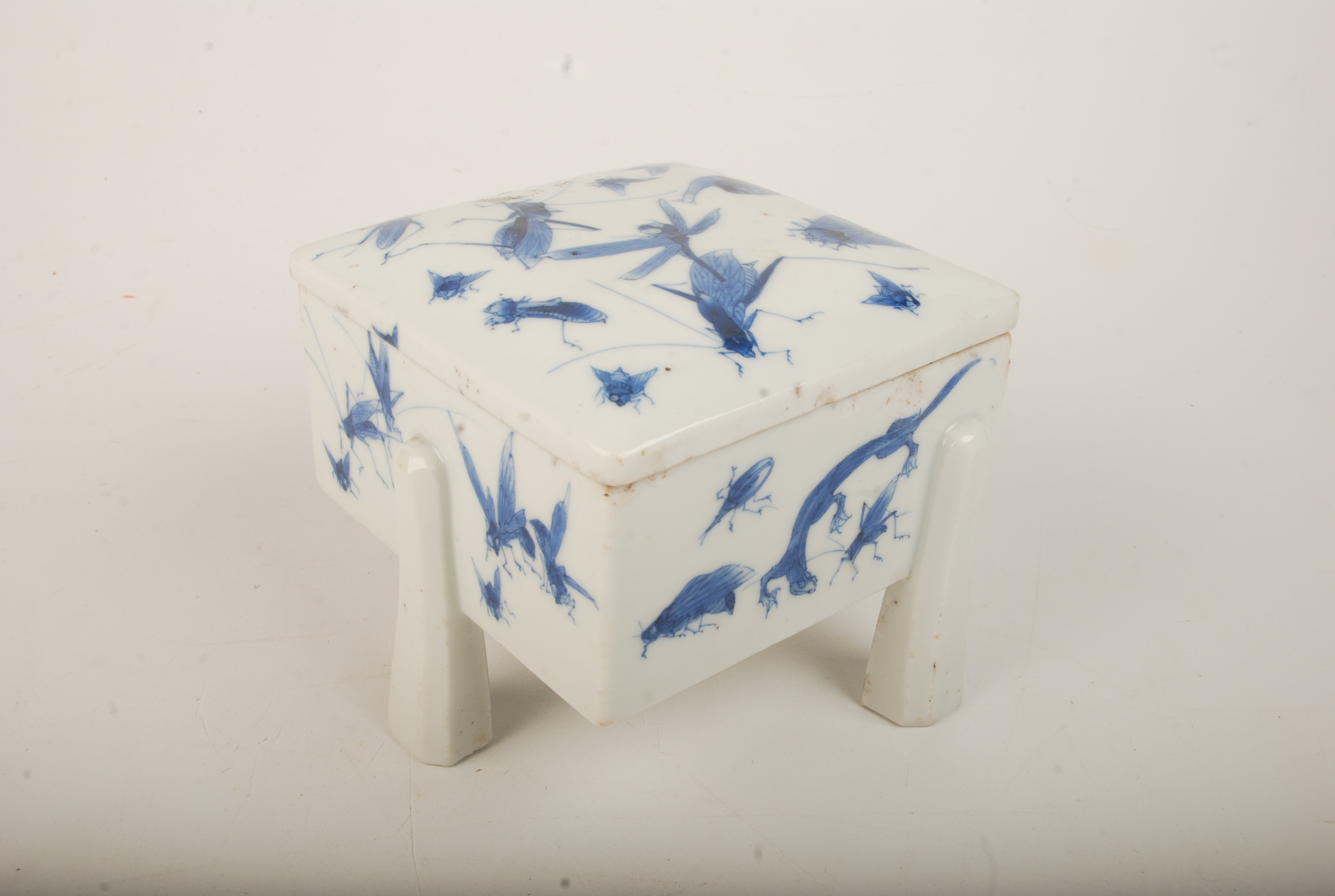 A Japanese blue and white porcelain box and cover, 19th century, decorated with insects and snails,