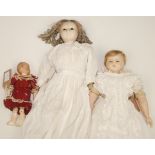 Three wax head dolls, the two larger are shoulder plates, one with wax forearms and legs,