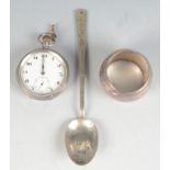 A silver cased pocket watch, a napkin ring and an eastern spoon.
