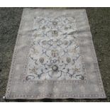 An Indian rug, the sky blue field with an all over design of palmettes, flowering vines and leaves,