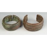 An African tribal heavy bronze upper arm band/cuff cast with three lines and a similar cuff with