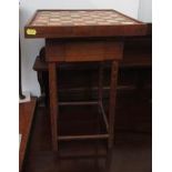 A composition chess set with associated oak table with an inset tiled board to the top,