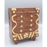 A slipware pottery money box, in the form of a chest of drawers, inscribed 'Savings Bank',
