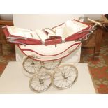 A late 1960s or early 1970s twin coach built pram by Royal in red and cream, full height 35".