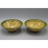 A pair of Clive Bowen Studio Pottery bowls, each with a wavy designed green and brown glazed border,
