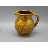 A Clive Bowen Studio Pottery mug, the ochre body with brown lines of zig zag to the base,
