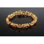 A Tiffany & Co 1950's 18ct gold bracelet each of the 14 cannetille crescents centred by a ruby,