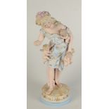 A bisque porcelain figure of a lady holding four cherubs 19th century,