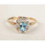 A 9ct gold aquamarine and diamond oval cluster ring.