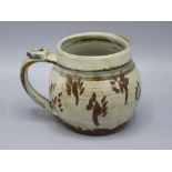 A Seth Cardew Studio Pottery mug, the grey ribbed body decorated with brown stylised flowers,