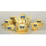 A 1930s tea set, the yellow ground decorated with stylised trees, comprising a tea pot,