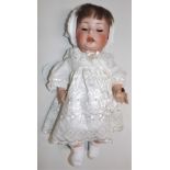 A porcelain head doll by Schoenau and Hoffmeister, the head with sleep eyes, open mouth,