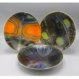 Three Poole Pottery lustre glazed dishes, each with polychrome abstract designs, diameters 26.