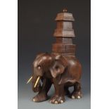 A carved hardwood figure of an elephant with a howdah on its back, height 29.5cm, width 18cm.