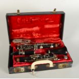 A Boosey & Hawkes Regent Clarinet, in a red velvet lined case, length of case 35cm.